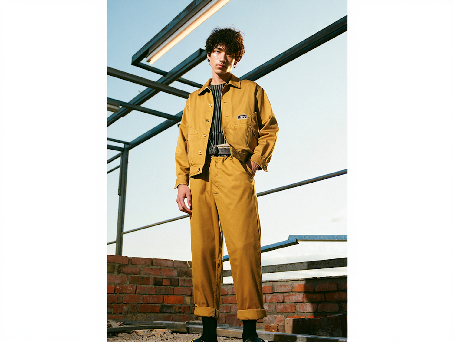 Builder in workwear on a framed construction site